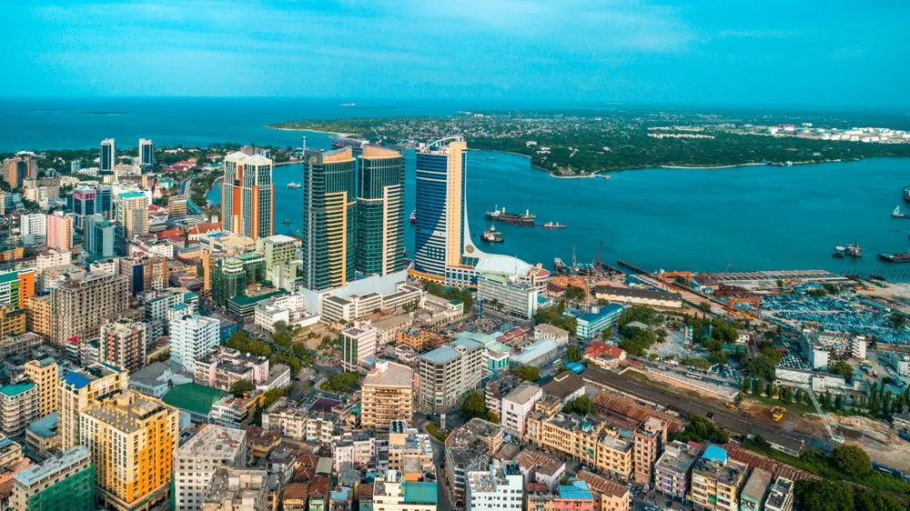 Aerial view of Dar es Salaam city, Tanzania, featuring buildings and ocean.