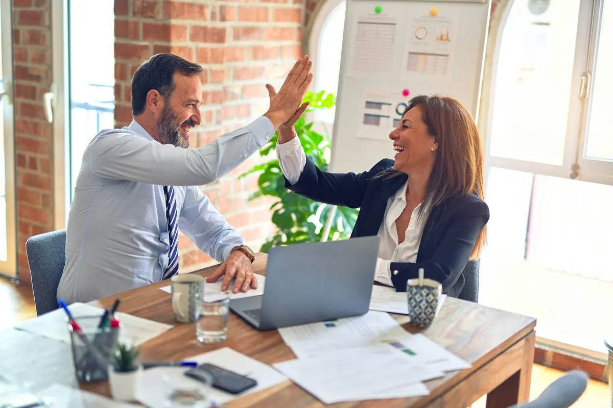 Investors at a meeting table — owning shares is not a Labour work permit