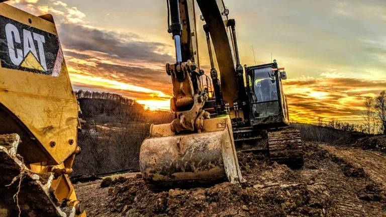 excavator on a mine site: mining local content is procurement, not a mineral right