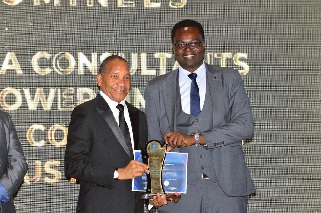 Zatra Consultants receiving an industry award on stage.