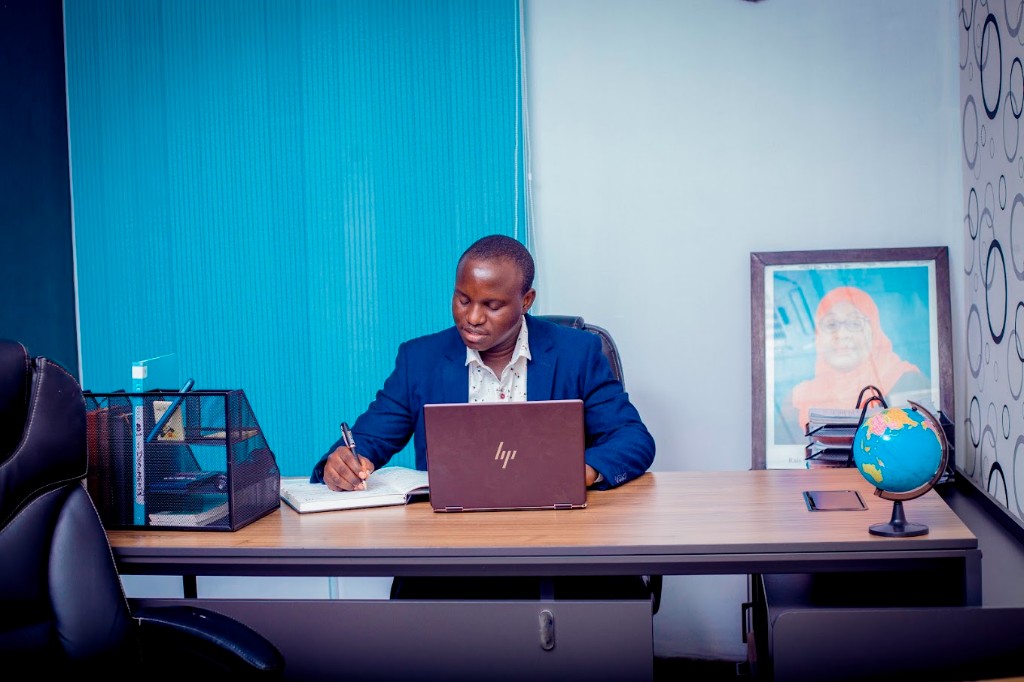 Zatra adviser preparing a Tanzania setup brief at the Dar es Salaam desk