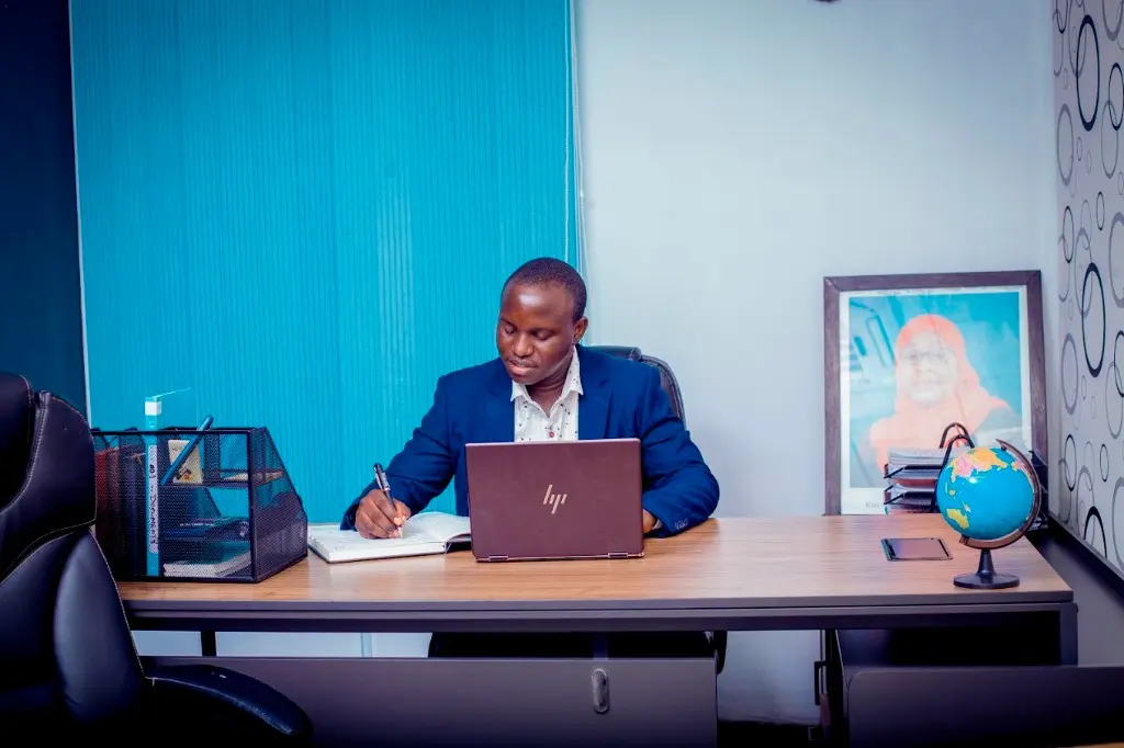 Zatra adviser preparing a Tanzania setup brief at the Dar es Salaam desk