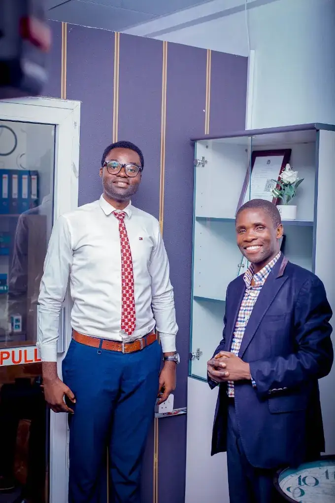 Two Zatra Consultants advisers at the entrance to the firm's Dar es Salaam office.